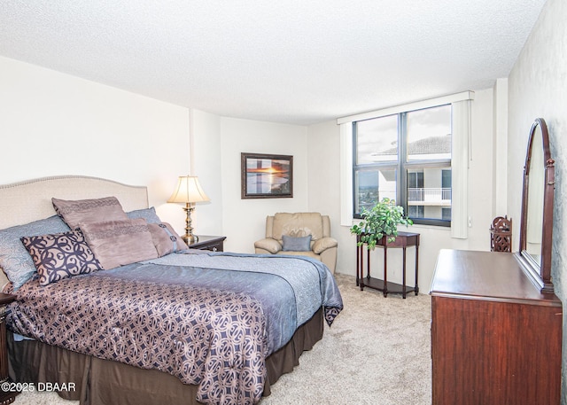 carpeted bedroom featuring a textured ceiling