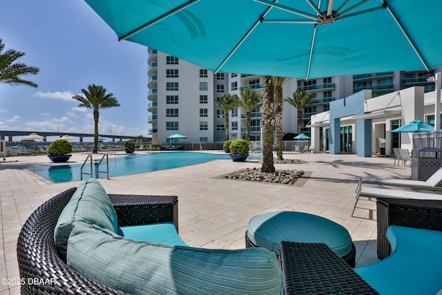 view of swimming pool featuring a patio area