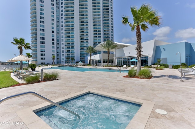 view of swimming pool featuring a community hot tub and a patio area