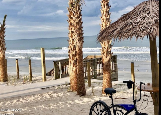 exterior space featuring a beach view and a water view