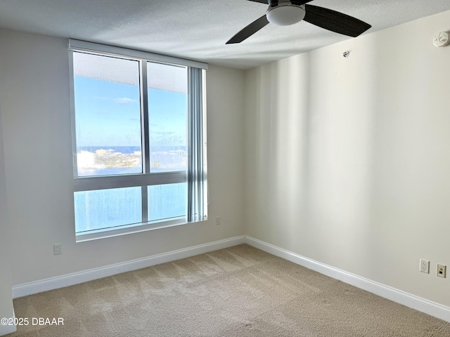 empty room featuring carpet flooring and ceiling fan