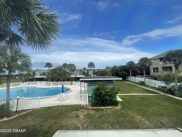 view of pool with a yard