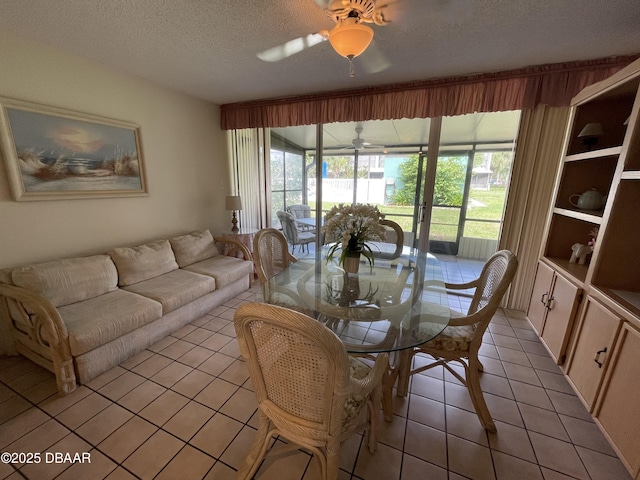 dining space featuring ceiling fan, light tile patterned floors, and a textured ceiling