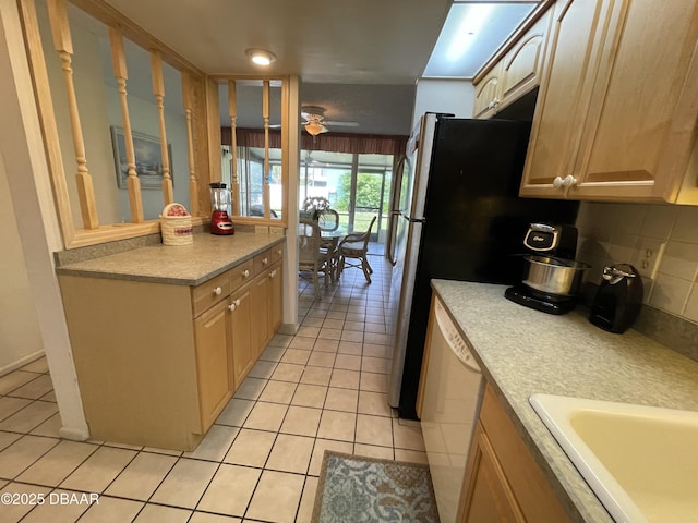 kitchen featuring ceiling fan, stainless steel dishwasher, decorative backsplash, light brown cabinetry, and light tile patterned floors