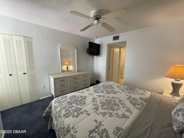 bedroom featuring carpet flooring, ceiling fan, a closet, and a textured ceiling