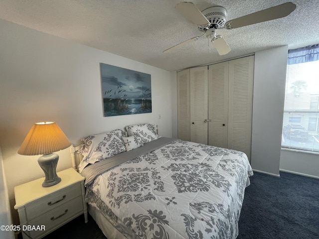 carpeted bedroom with multiple windows, ceiling fan, a closet, and a textured ceiling