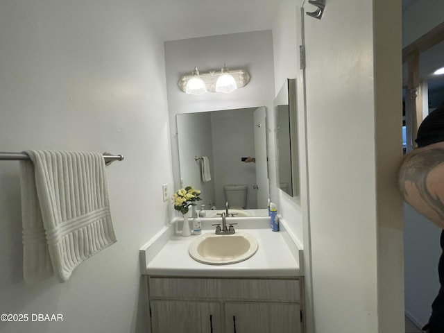 bathroom featuring vanity and toilet