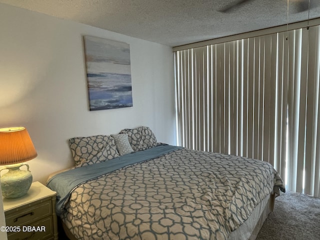 carpeted bedroom featuring a textured ceiling