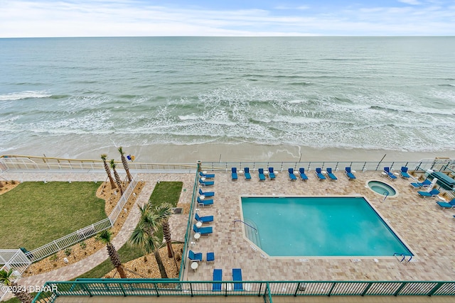 aerial view with a water view and a view of the beach