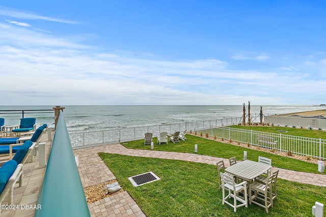 surrounding community with a yard, a water view, and fence