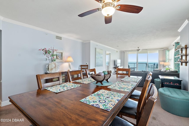 dining area featuring ceiling fan, visible vents, and ornamental molding