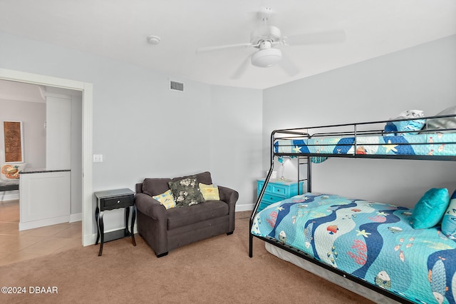bedroom with baseboards, a ceiling fan, light colored carpet, and visible vents