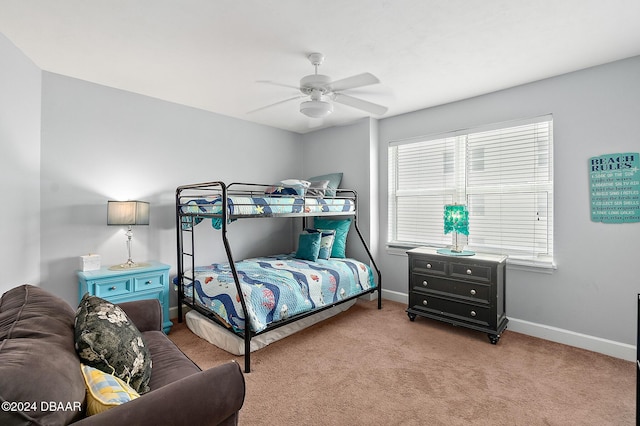 bedroom with baseboards, a ceiling fan, and light carpet