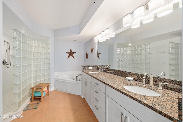 full bathroom with a sink, walk in shower, tile patterned floors, and a bath