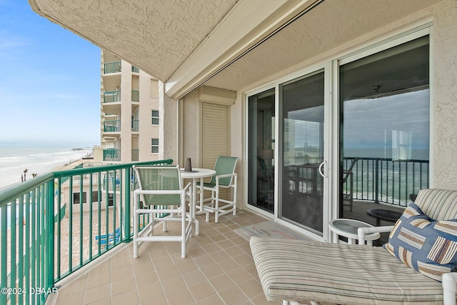 balcony with a view of the beach and a water view