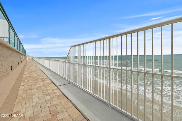 exterior space with a water view and a view of the beach