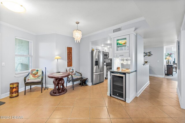 3311 S Atlantic Ave Unit 304, Daytona Beach Shores, FL 32118 - kitchen with wine cooler, glass insert cabinets, white cabinets, light tile patterned floors, and stainless steel appliances