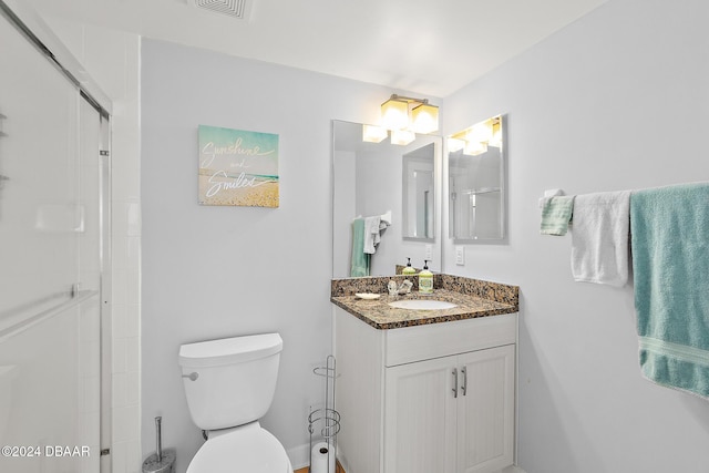 full bath featuring vanity, a shower with shower door, toilet, and visible vents