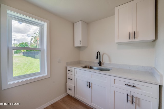 259 Jefferson St, Daytona Beach, FL 32114 - kitchen featuring white cabinets, light countertops, and light wood-type flooring