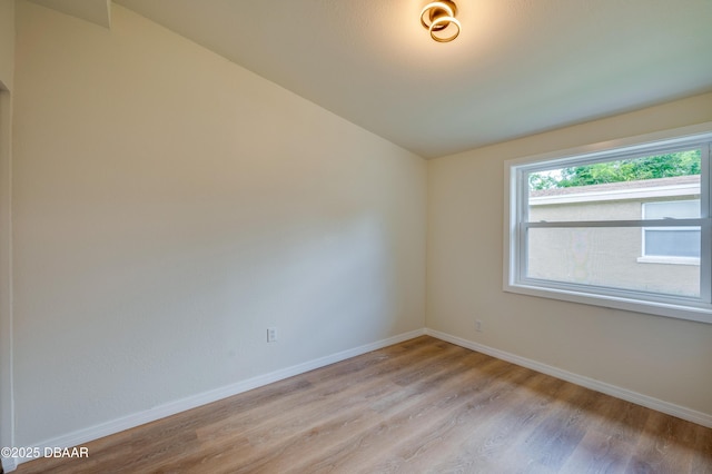 259 Jefferson St, Daytona Beach, FL 32114 - spare room with light wood-type flooring and lofted ceiling