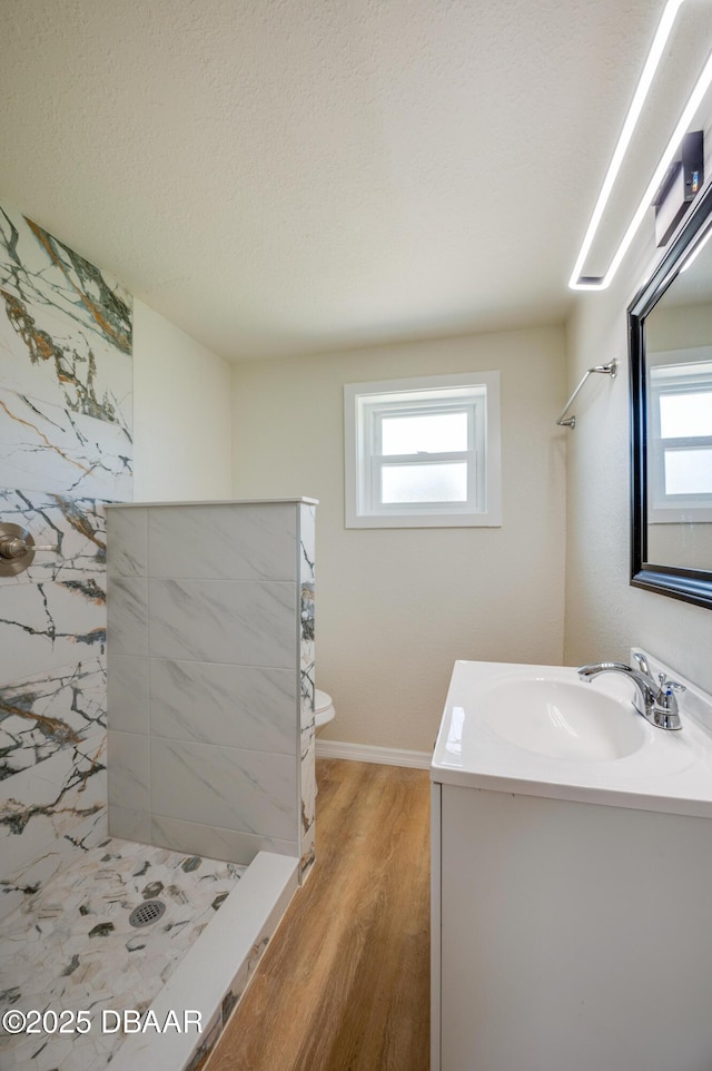 259 Jefferson St, Daytona Beach, FL 32114 - full bathroom featuring a tile shower, vanity, plenty of natural light, and wood finished floors