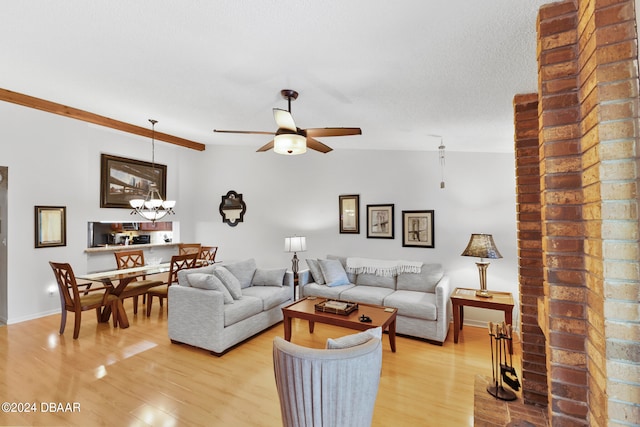 living room featuring light wood-type flooring, ceiling fan with notable chandelier, and lofted ceiling