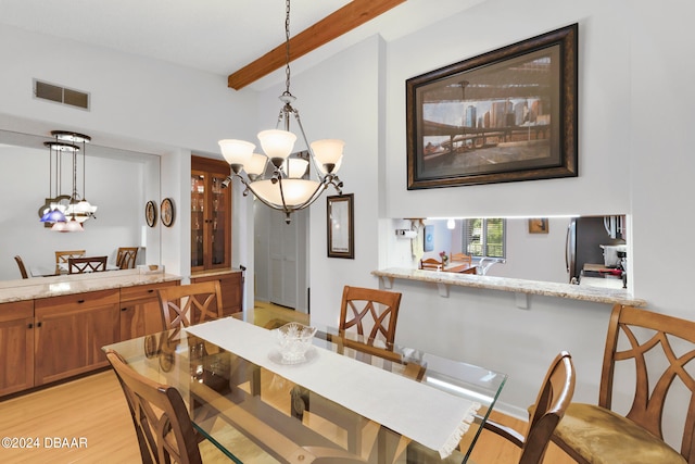 dining room with light hardwood / wood-style floors, a notable chandelier, and beamed ceiling