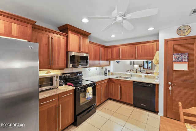 kitchen featuring light stone counters, black appliances, sink, light tile patterned floors, and ceiling fan