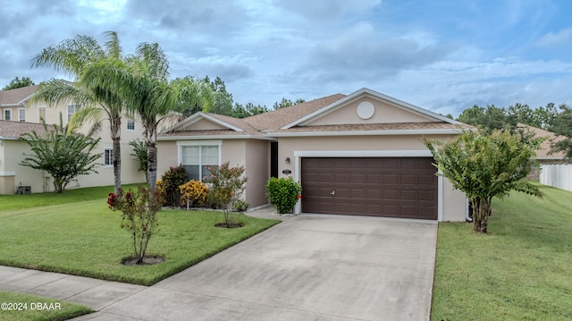 single story home featuring a garage and a front yard