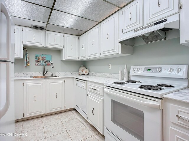 1415 Ocean Shore Blvd Unit 309, Ormond Beach, FL 32176 - kitchen featuring white appliances, a sink, under cabinet range hood, white cabinetry, and a drop ceiling