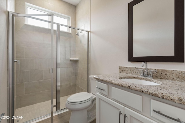 bathroom featuring an enclosed shower, vanity, toilet, and wood-type flooring