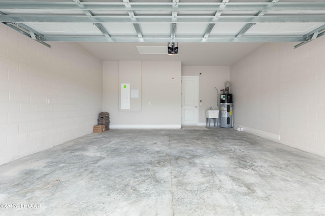 garage with a garage door opener, sink, and hybrid water heater