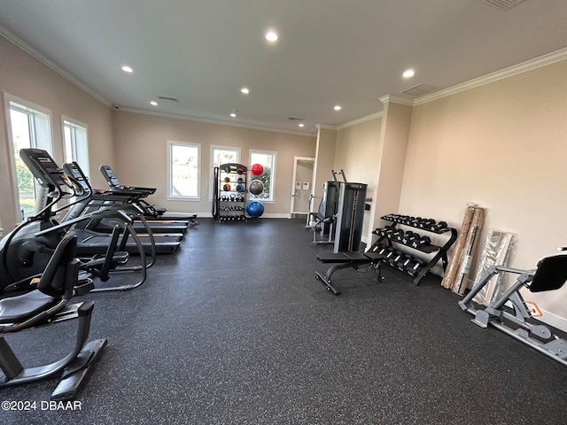 workout area featuring crown molding