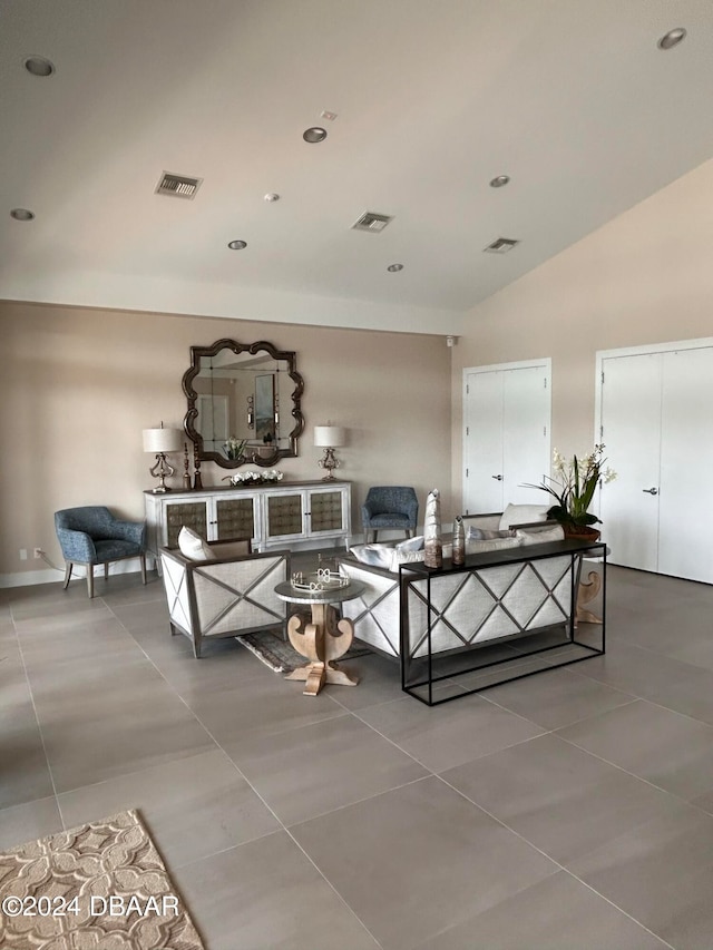 living room featuring tile patterned floors and lofted ceiling