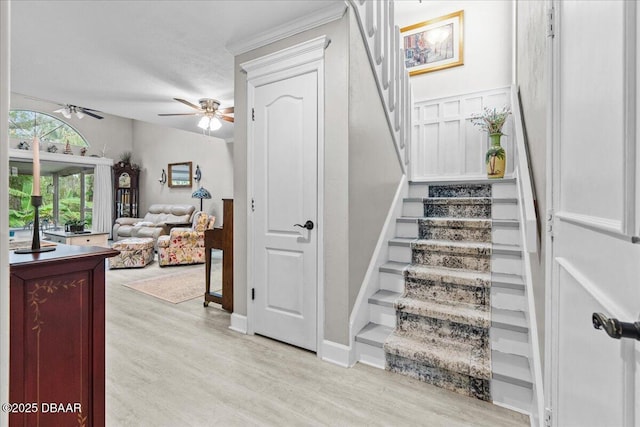 stairway with hardwood / wood-style flooring and ceiling fan