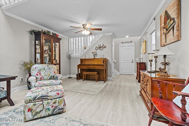 sitting room featuring crown molding, ceiling fan, and light hardwood / wood-style floors