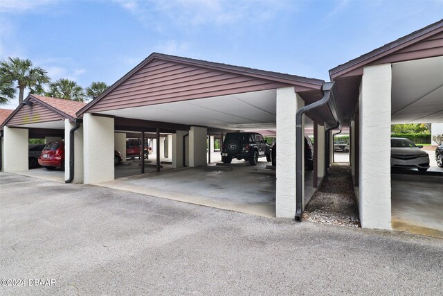 view of vehicle parking with a carport