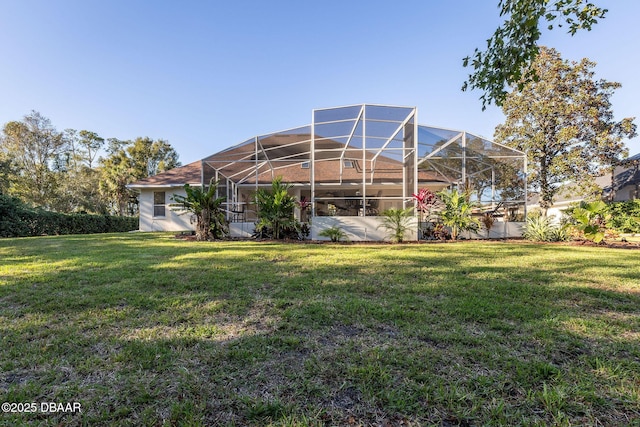 back of property featuring a lanai and a yard