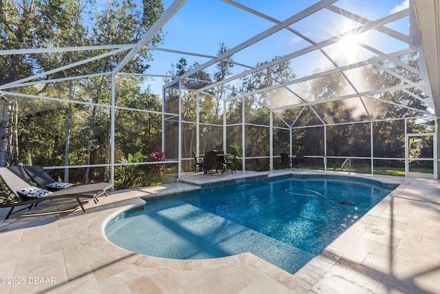 outdoor pool featuring a patio and glass enclosure
