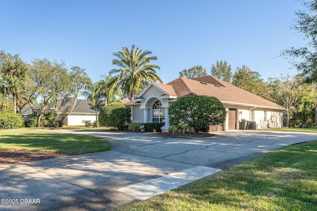 view of front facade featuring a garage, driveway, a front yard, and stucco siding
