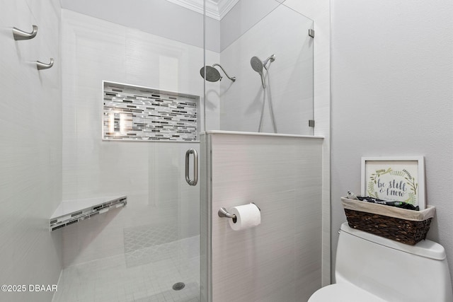 full bathroom featuring ornamental molding, toilet, and a shower stall