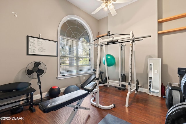 exercise room featuring baseboards, a ceiling fan, and wood finished floors