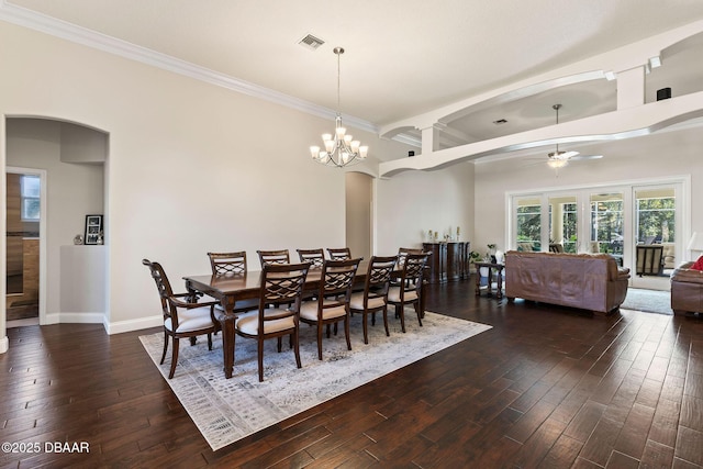 dining space with arched walkways, ceiling fan, dark wood finished floors, and visible vents