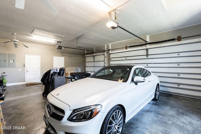 garage featuring a ceiling fan, a garage door opener, and electric panel
