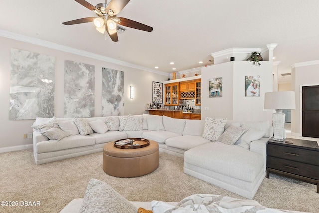 carpeted living area featuring indoor wet bar, recessed lighting, a ceiling fan, visible vents, and ornamental molding