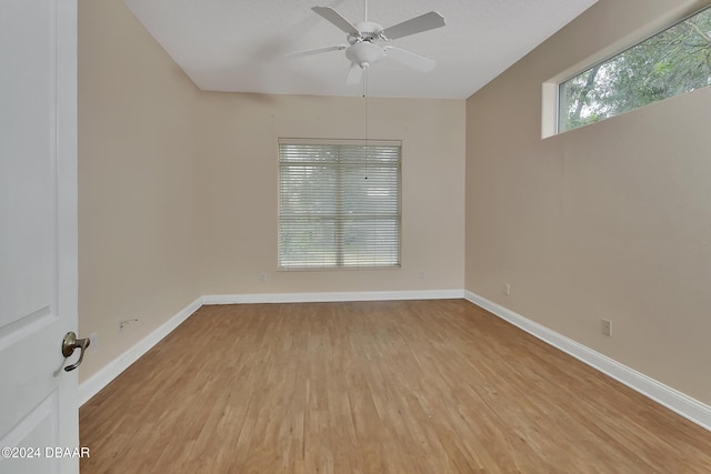 spare room with ceiling fan and light hardwood / wood-style floors