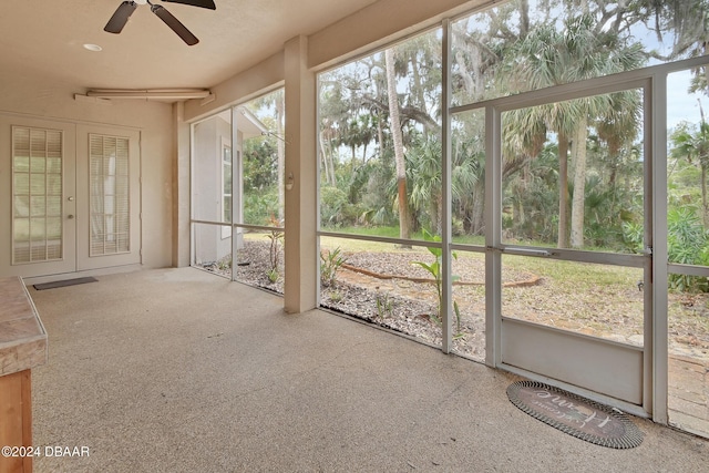 unfurnished sunroom with french doors, plenty of natural light, and ceiling fan