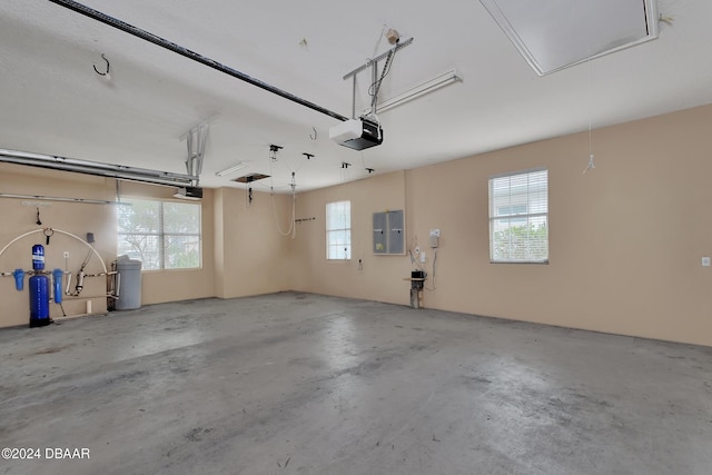 garage with electric panel and a garage door opener