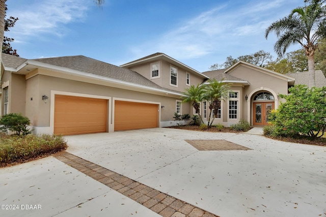 view of front of house featuring a garage and french doors