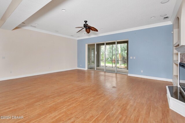 unfurnished living room with ceiling fan, crown molding, a textured ceiling, and light hardwood / wood-style flooring